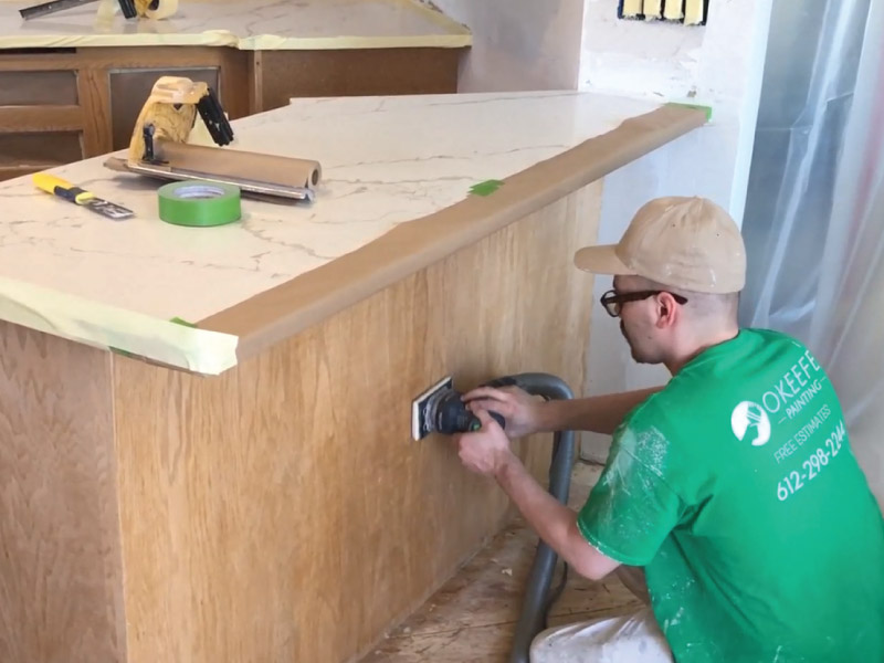 Scuff sanding cabinet boxes prior to paint application