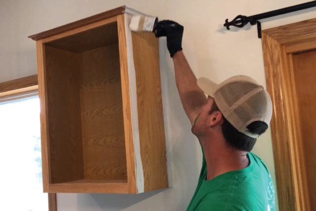 Brush and roll application of oil primer to cabinet boxes