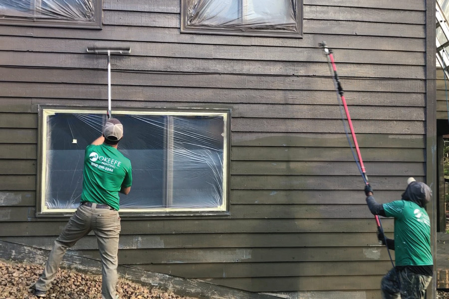 House painters painting a cedar sided home in Minneapolis