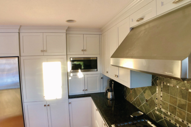 Stainless steel appliances with painted cabinets