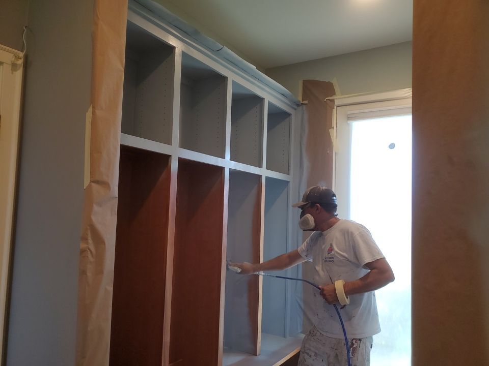 Professional painter priming built in cabinets
